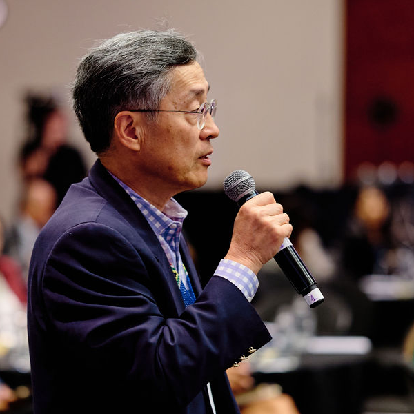 A man from an ILDS member organisation speaking at an event.