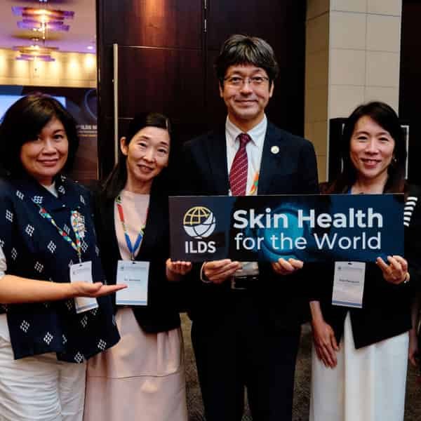 ILDS members standing together holding an ILDS Skin Health for the World sign