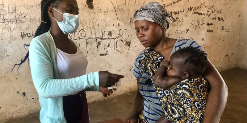 Healthcare worker with woman in Malawi
